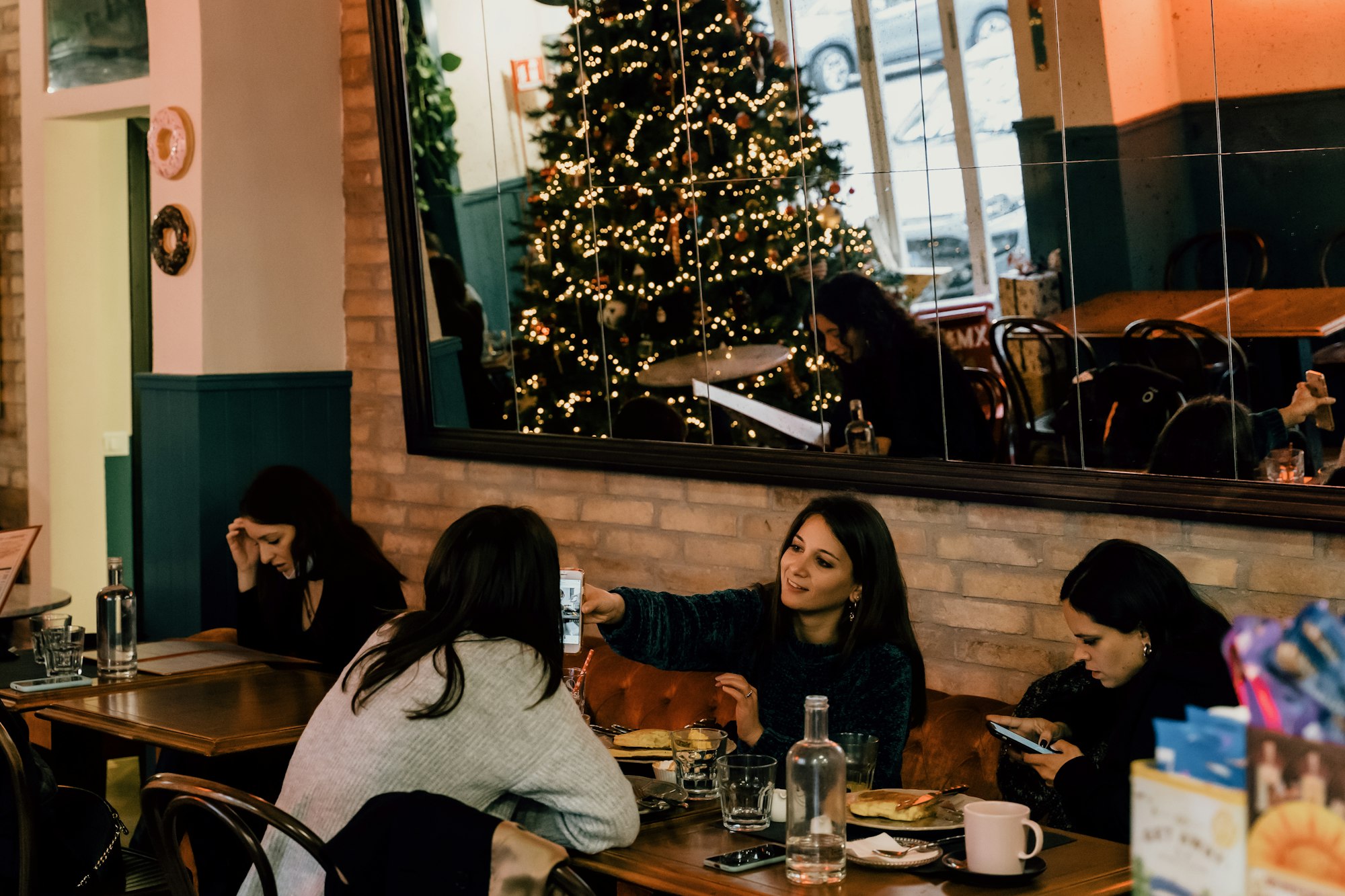 Friends are reunited at a restaurant during the December holidays.