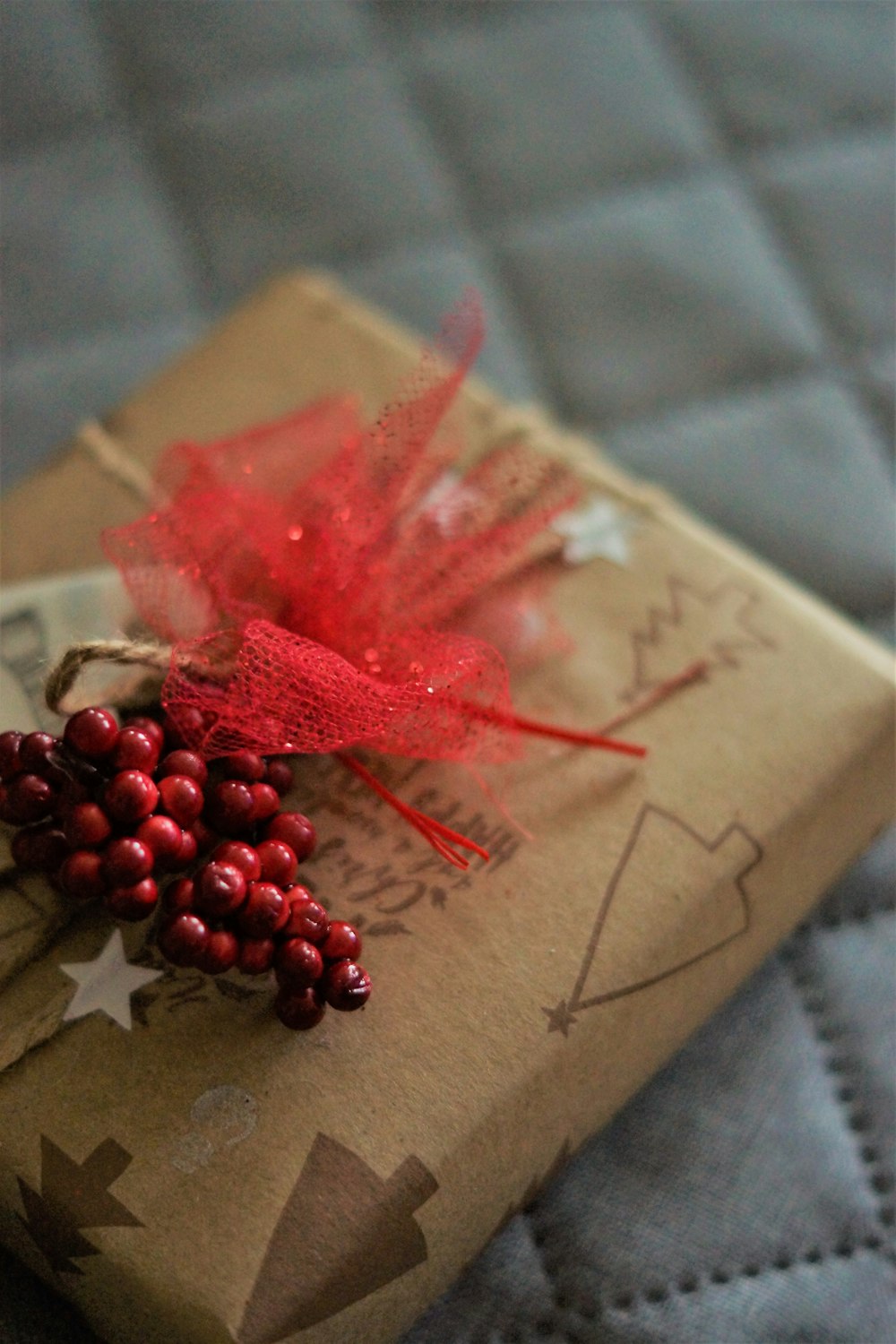 a present wrapped in brown paper with a red bow