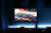 A neon-lit gaming setup with a glowing keyboard and a GTA 5 mod gameplay on screen.