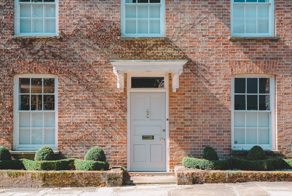 brown brick building with white wooden door