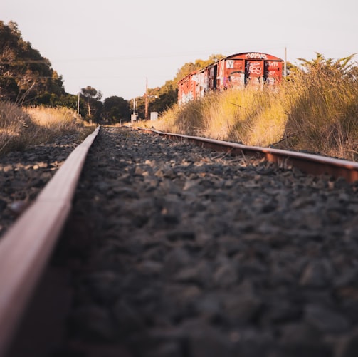 train rail near brown building during daytime