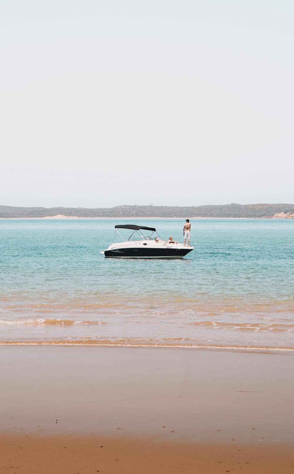 white and black boat on sea during daytime