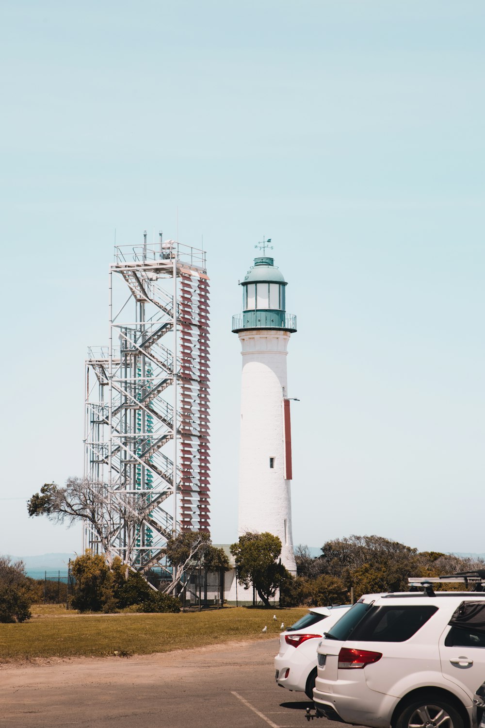 white and red tower under white sky during daytime