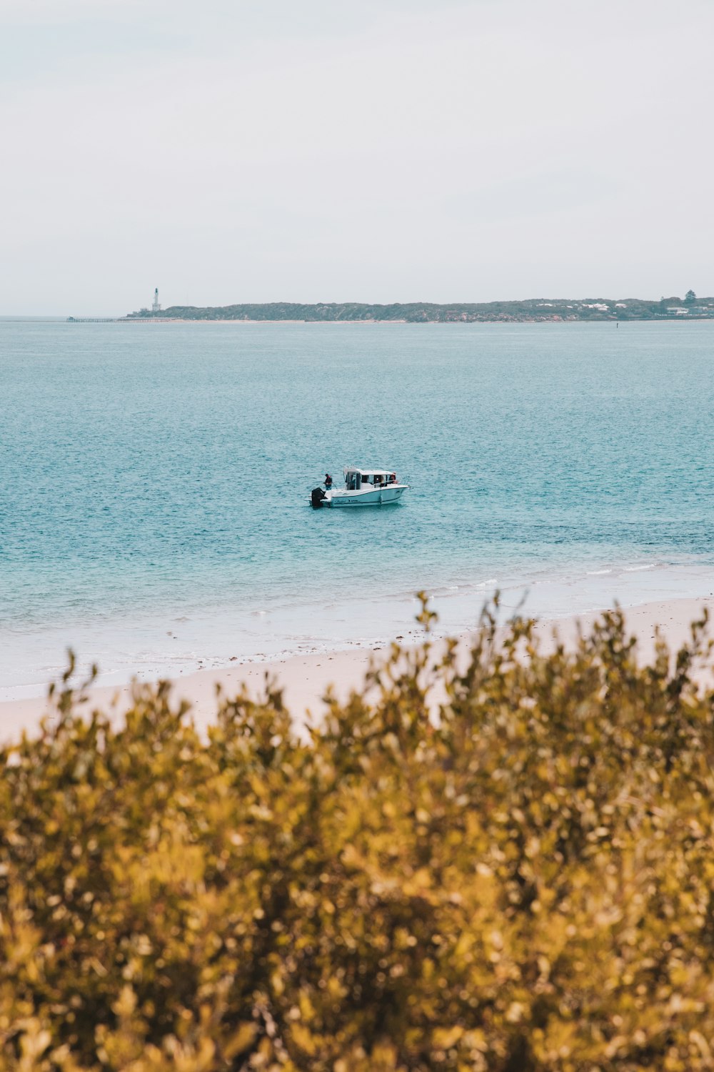 white boat on blue sea water during daytime