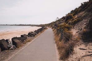 Scenic coastal route near Exmouth with runners passing by the sea