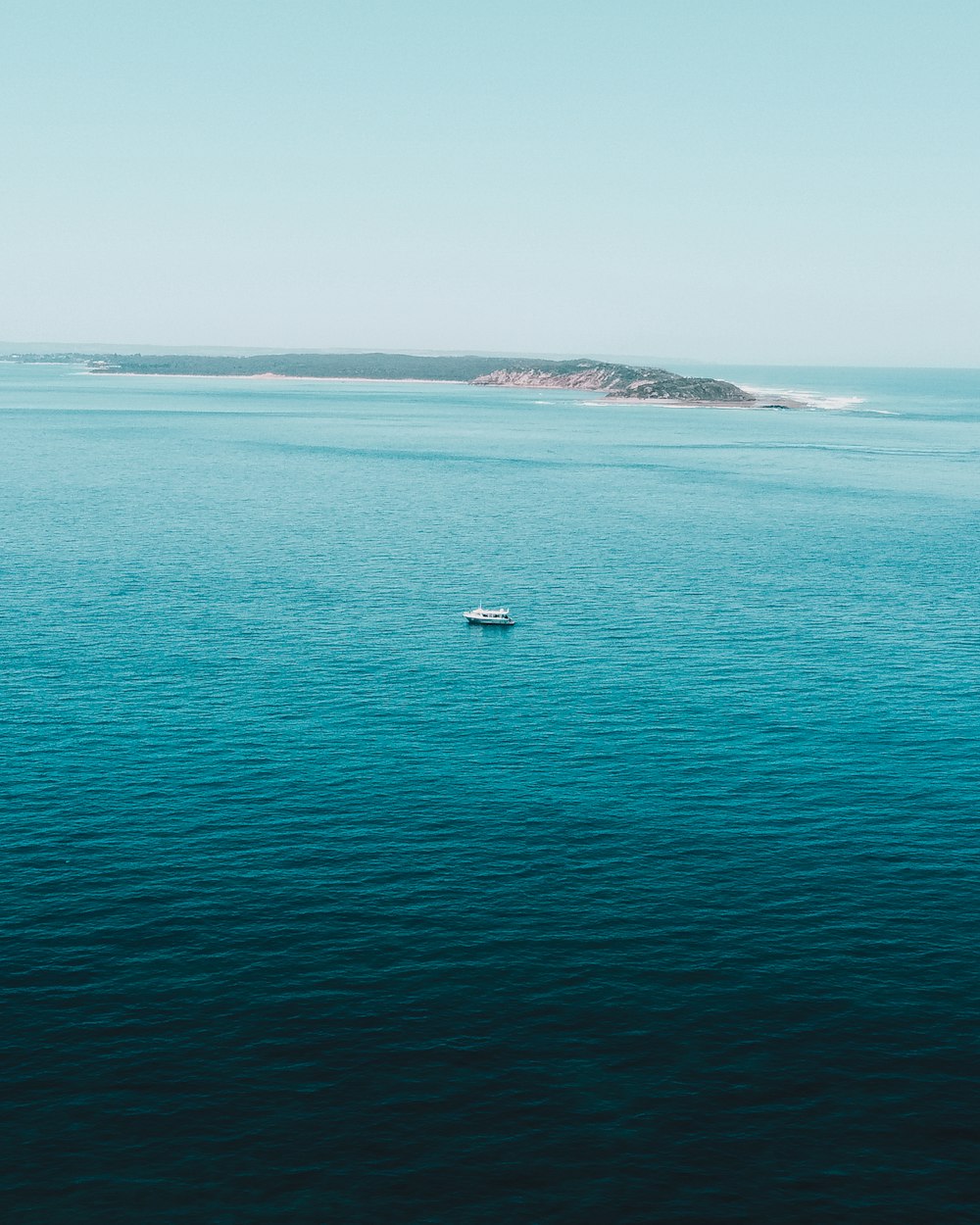 white boat on sea during daytime