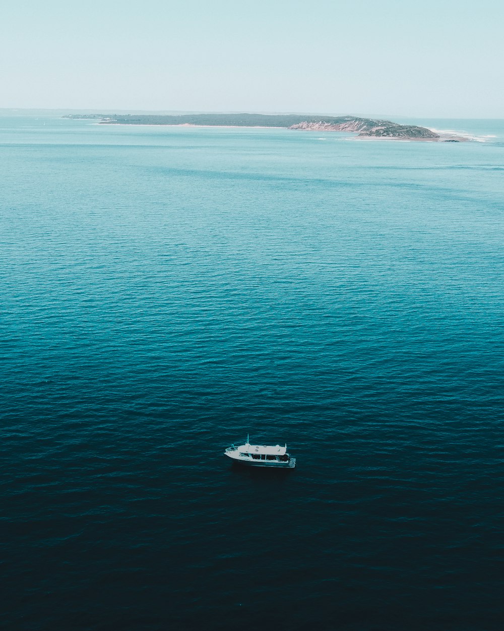 white boat on blue sea during daytime