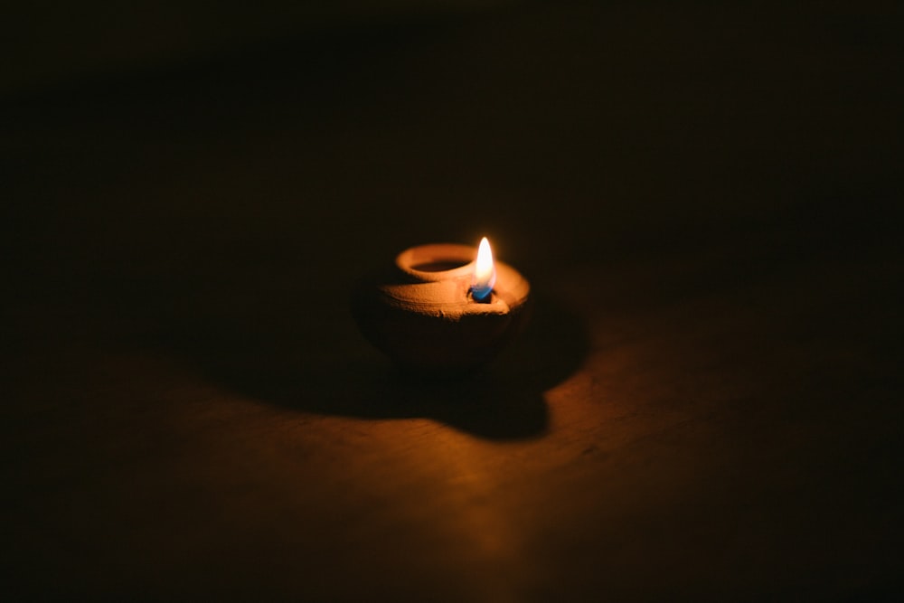 lighted candle in dark room