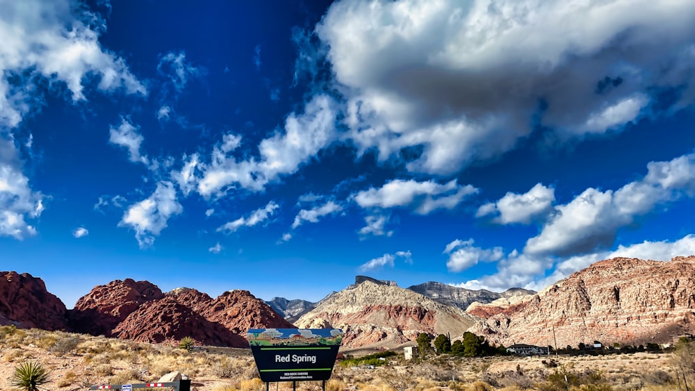 brown mountain under blue sky and white clouds during daytime