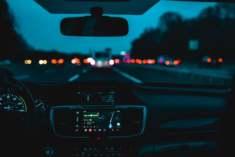 Blurred taillights on a dark highway seen from behind the steering wheel