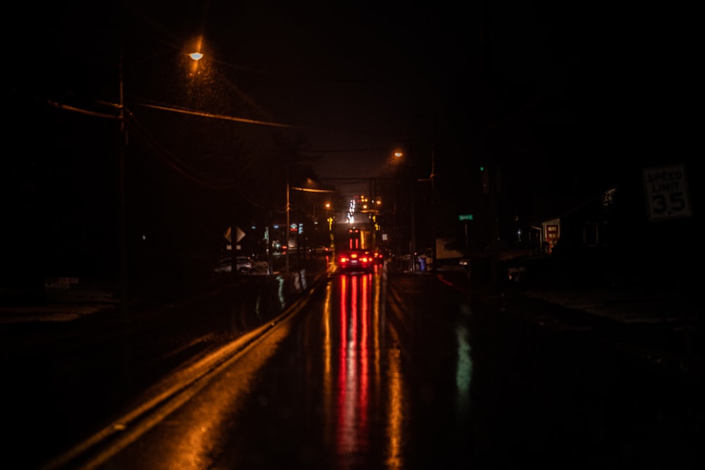 red and white light streaks on road during night time