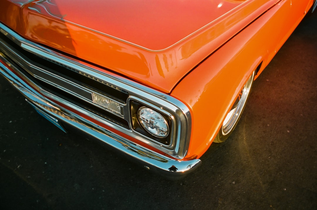 orange car on black asphalt road