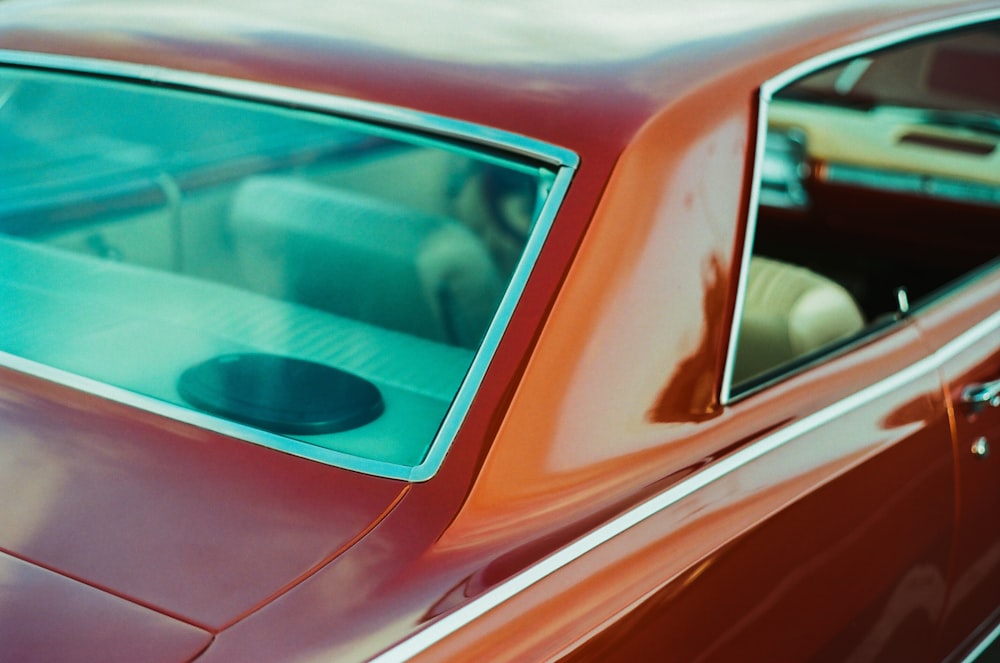 a close up of a red car with a person in it