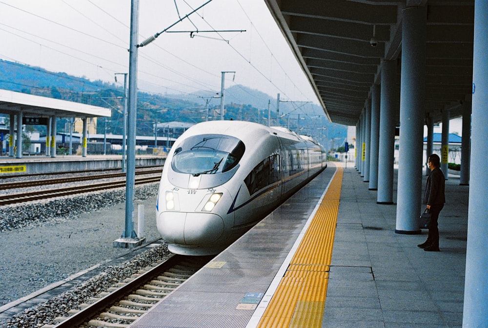 white bullet train on rail way during daytime