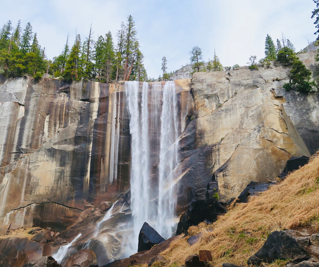 waterfalls on brown rocky mountain during daytime