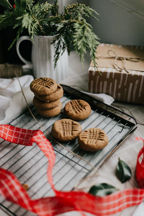 A cozy home bakery setup with baking tools and trays of cookies ready to package.