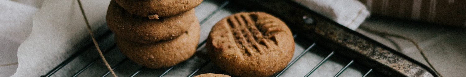 cookies on black tray beside brown cookies