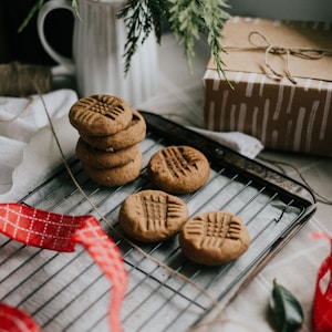 cookies on black tray beside brown cookies