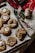 A warm kitchen scene with freshly baked sugar cookies cooling on a festive holiday-themed tray.