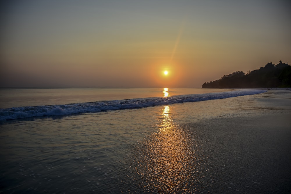 body of water during sunset