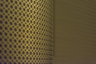 Steel sheet perforation process showing detailed holes for ventilation.