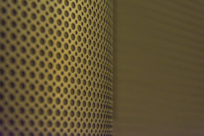 Steel sheet perforation process showing detailed holes for ventilation.