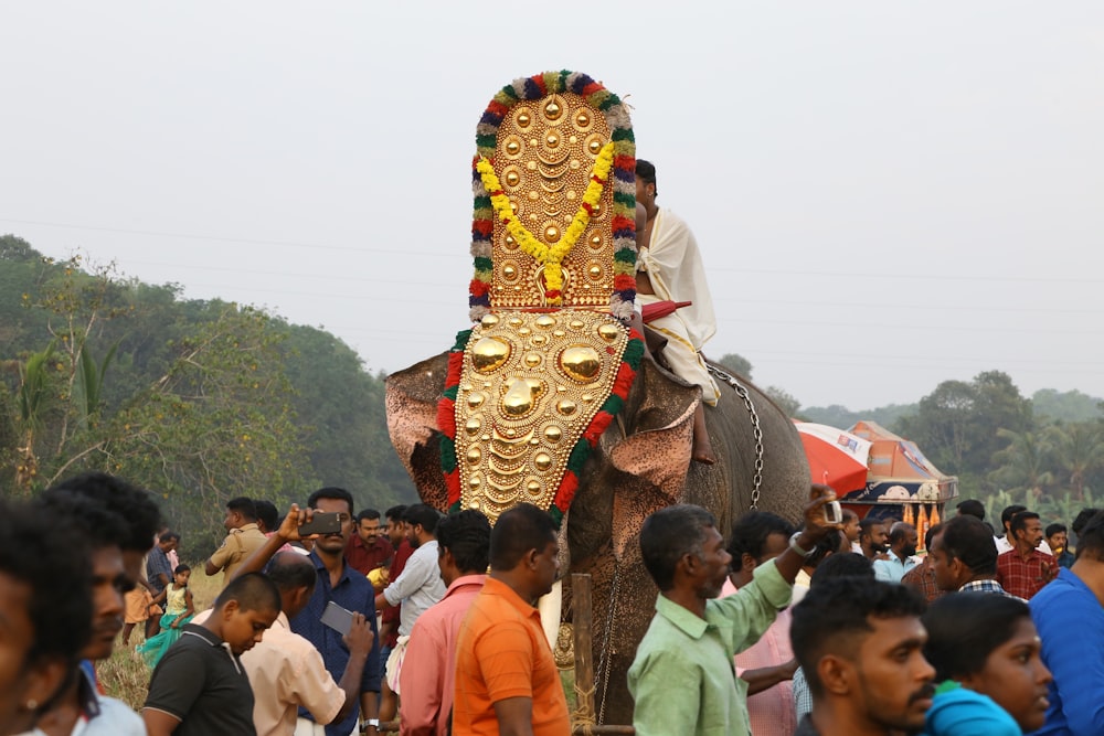 people gathering near brown and red dragon statue during daytime