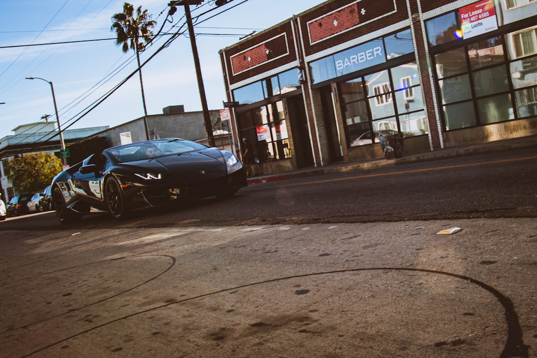 blue car parked near store during daytime