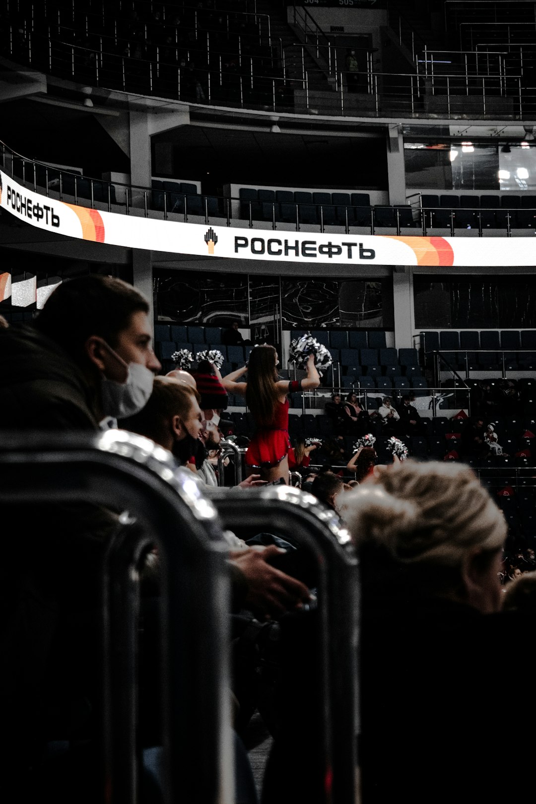 people sitting on black chairs inside stadium