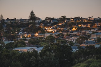 city with high rise buildings near body of water during night time