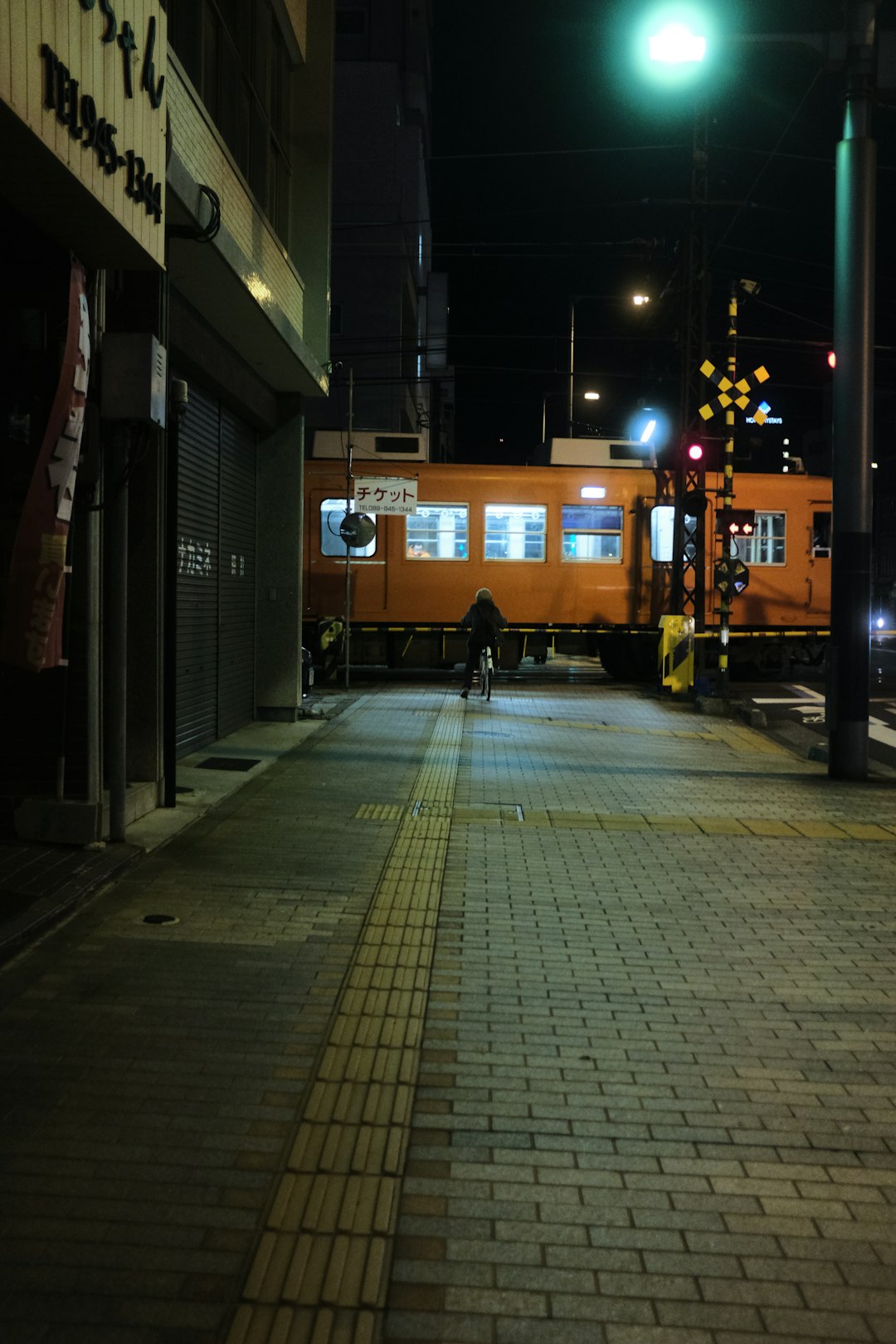brown and white train on the street during night time