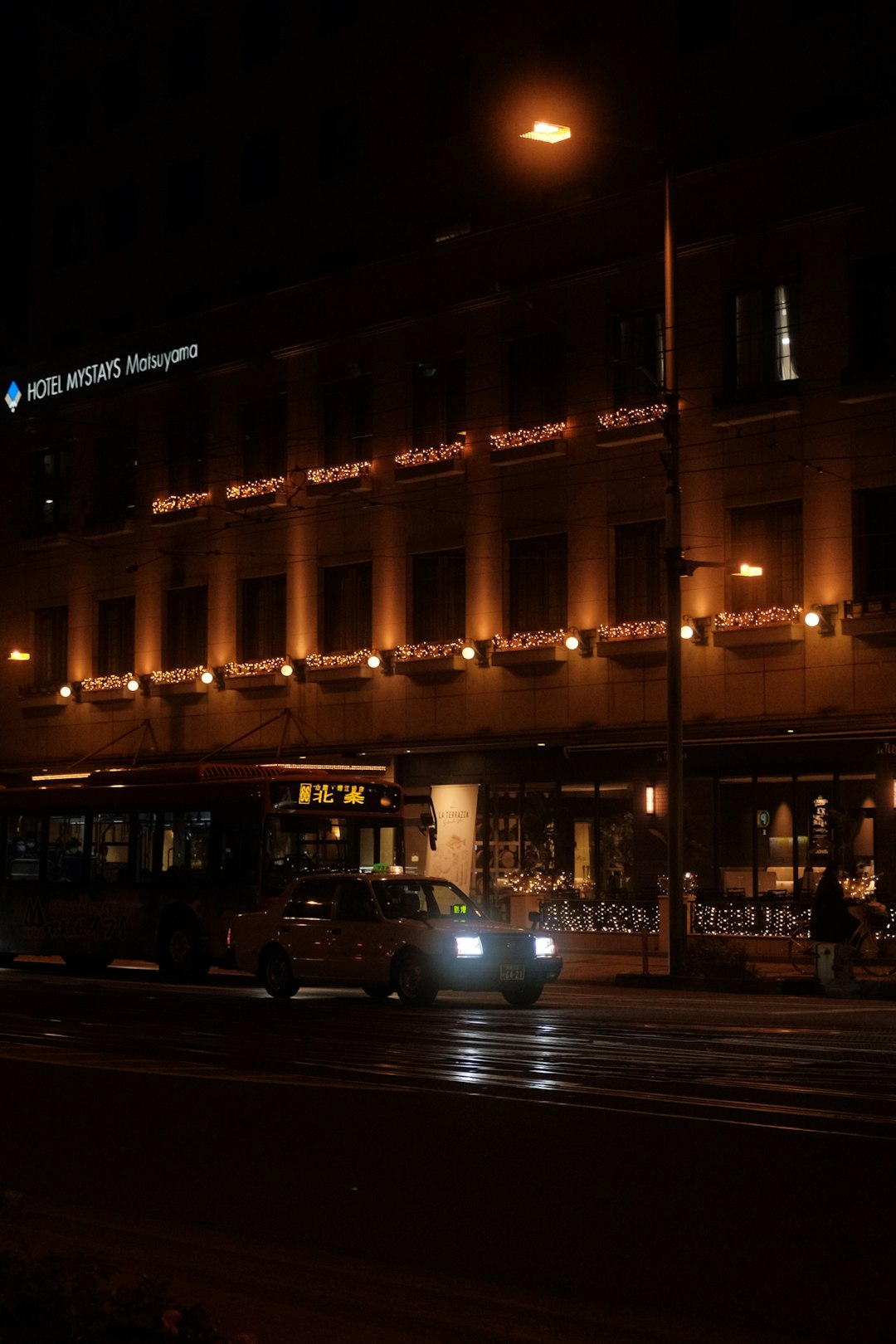 cars parked in front of building during night time