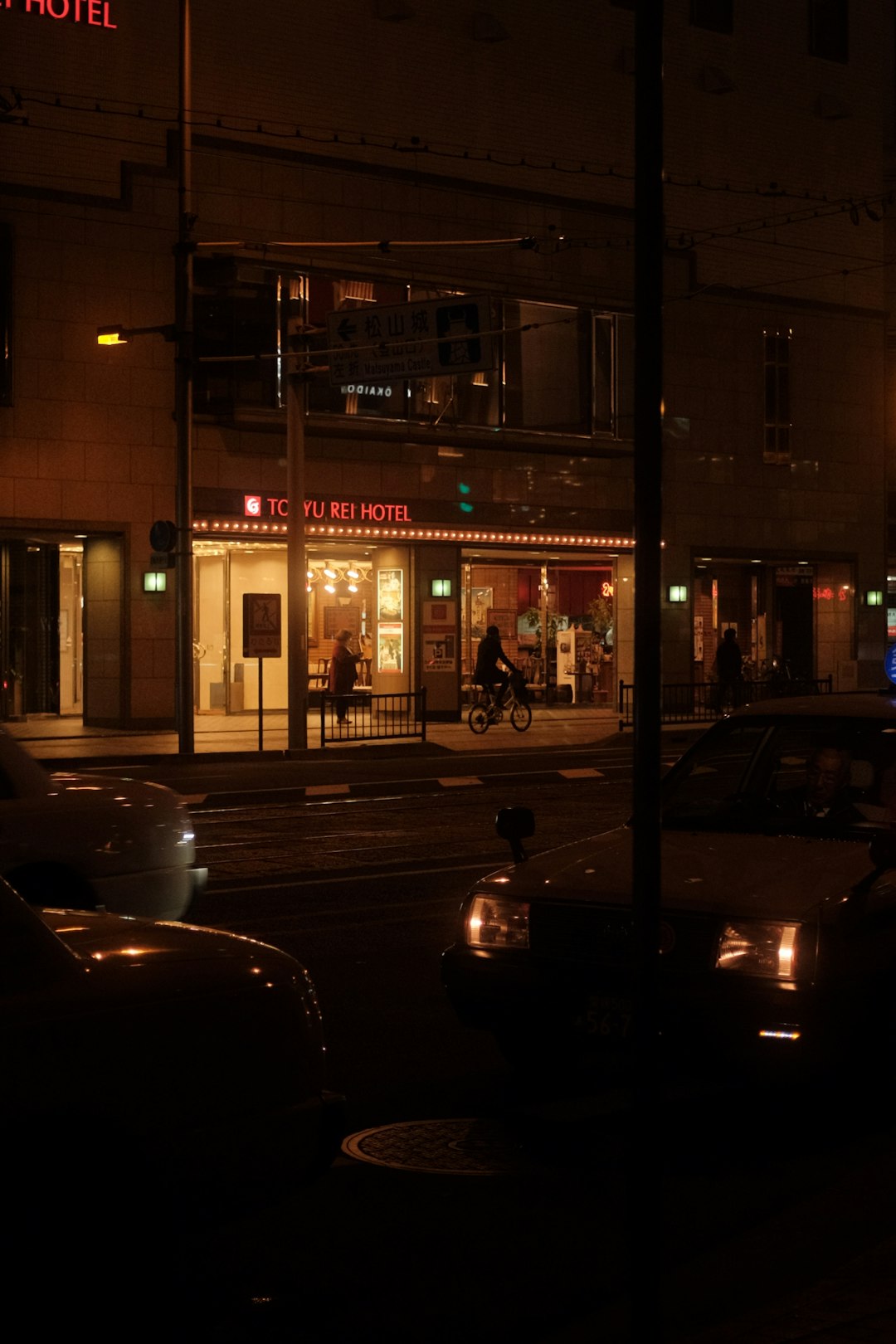 cars parked in front of building during night time