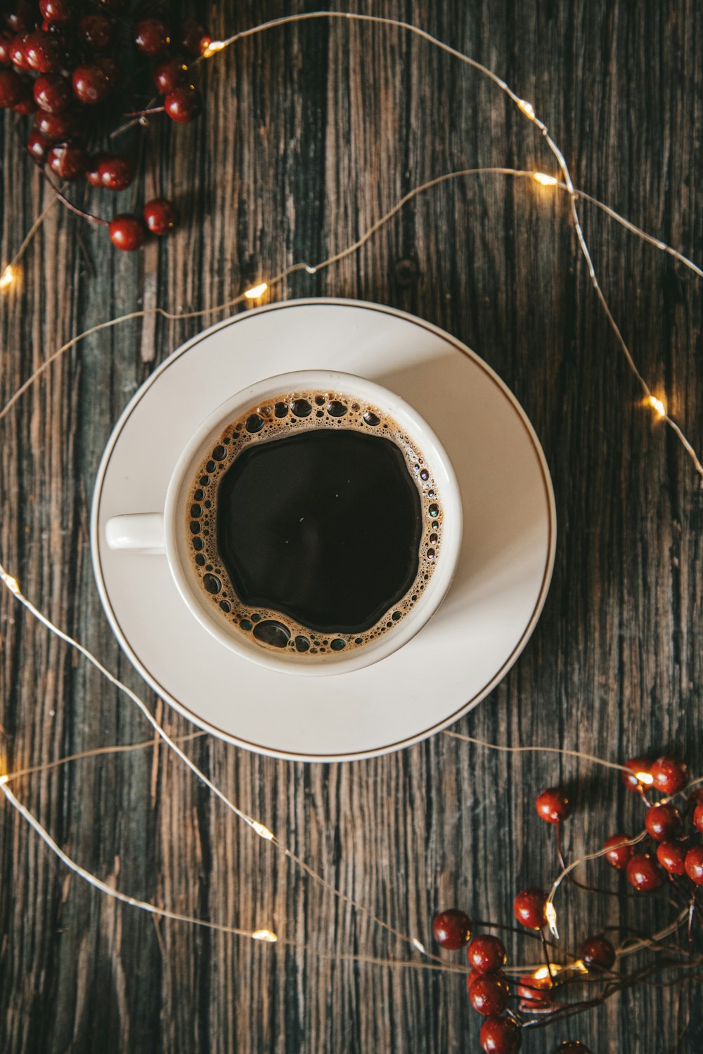 white ceramic cup with black liquid on white ceramic saucer