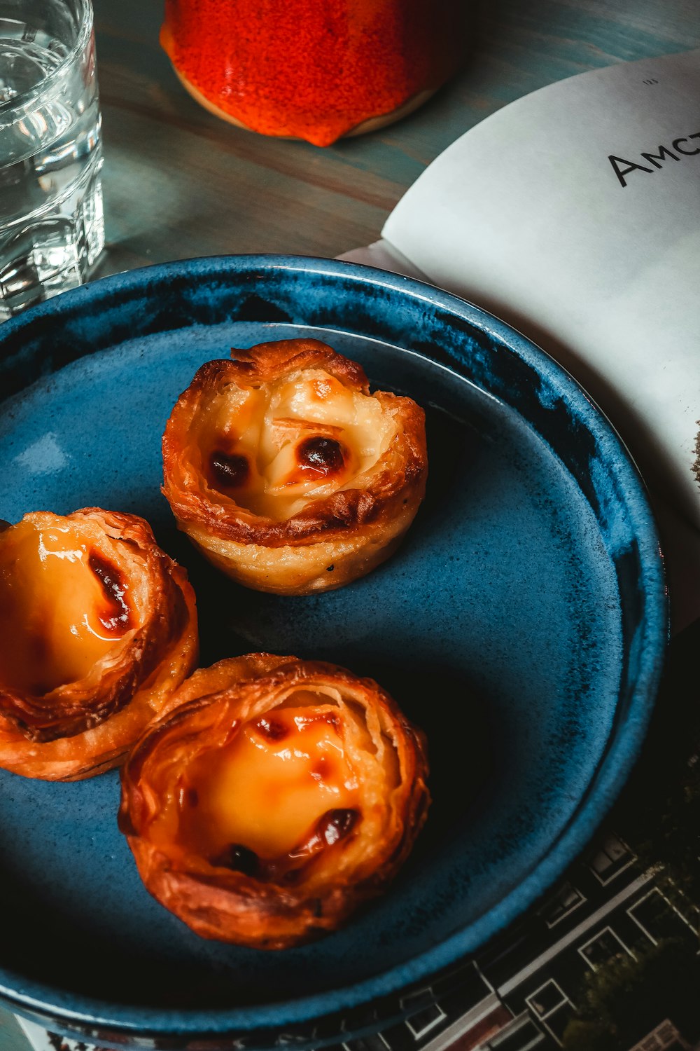 two brown doughnuts on blue round plate