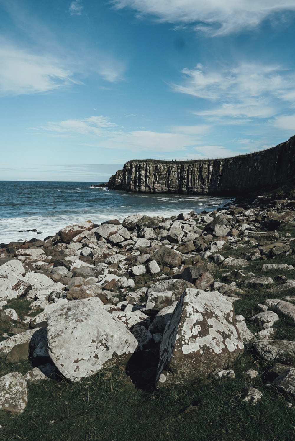 gray rocky shore under blue sky during daytime