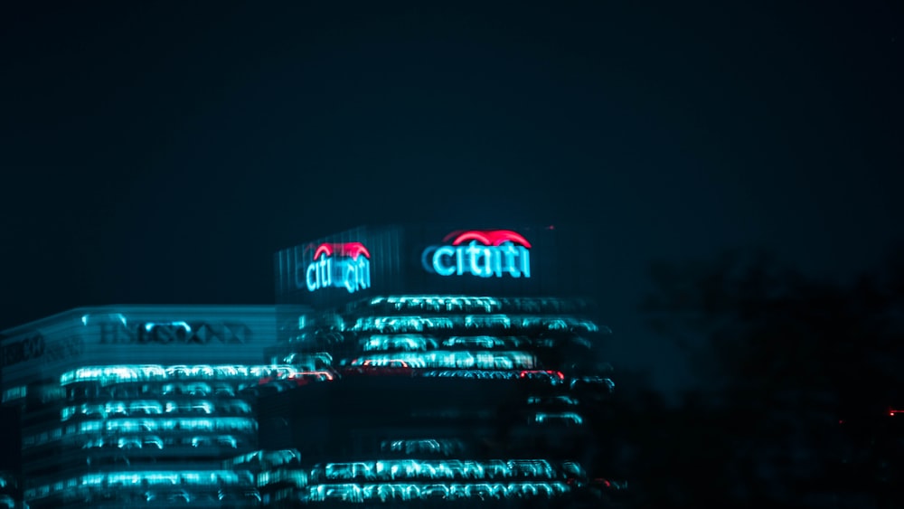 a building lit up at night with lights on it