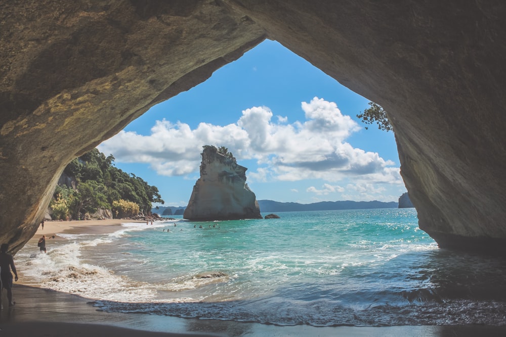 brown rock formation on sea during daytime