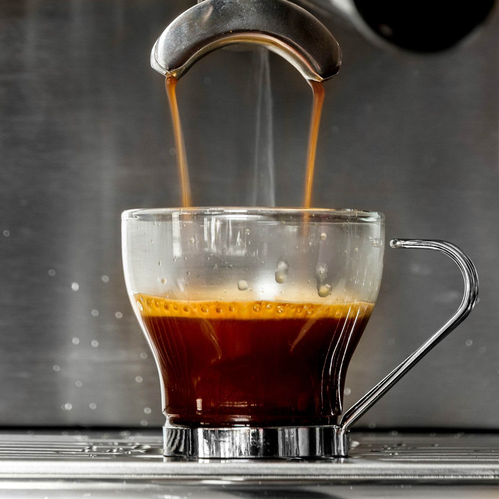 clear glass mug with brown liquid