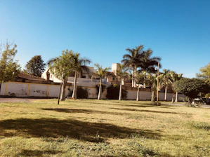 A modern residential lot with clear boundaries and green grass under a bright sky.