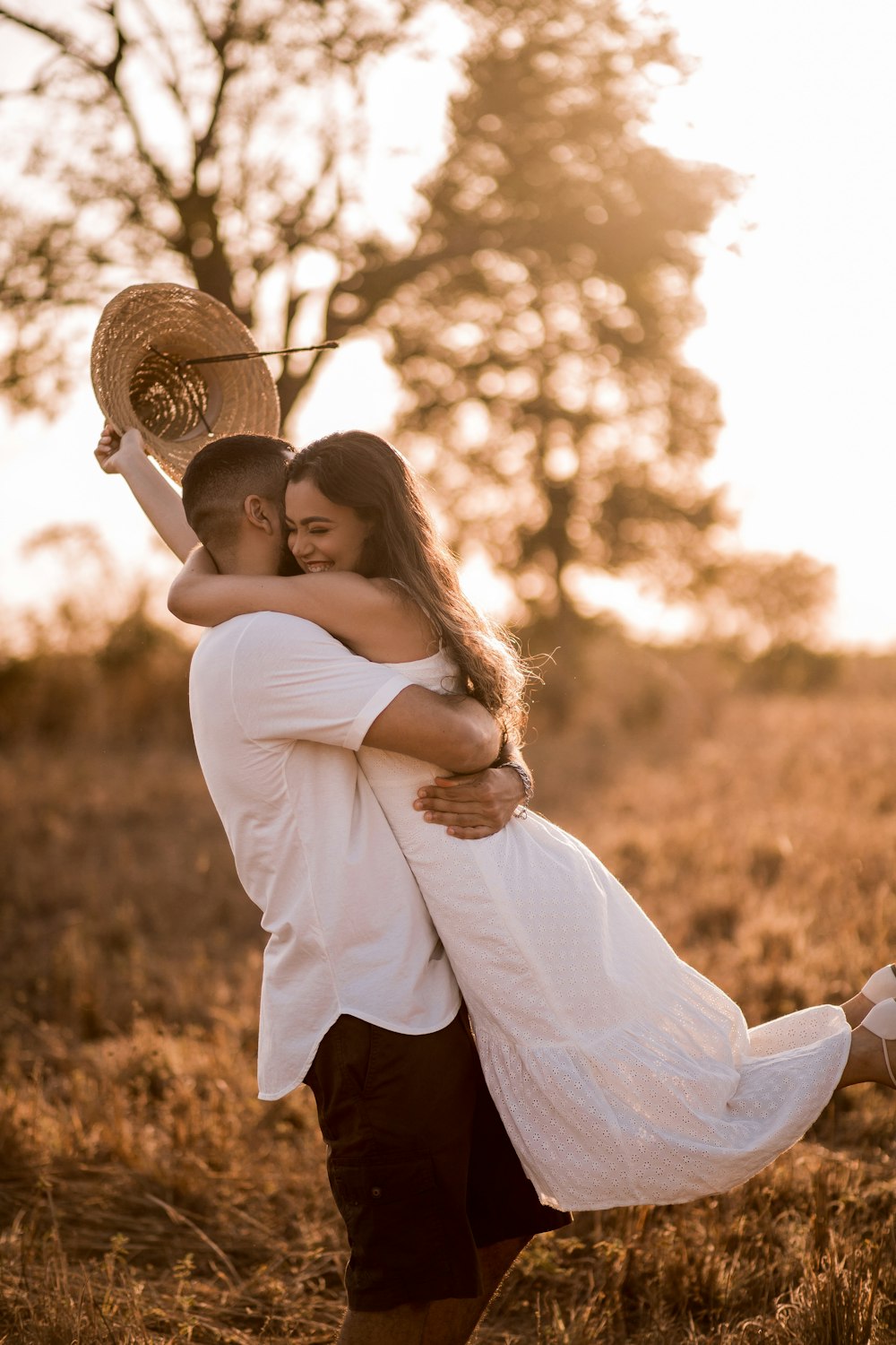 woman in white long sleeve shirt and black skirt wearing brown sun hat