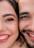 man and woman smiling while taking selfie