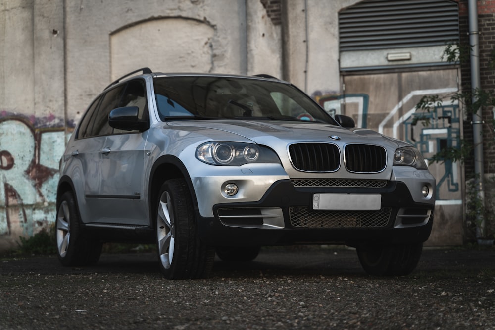 black bmw x 6 parked on gray concrete floor during daytime