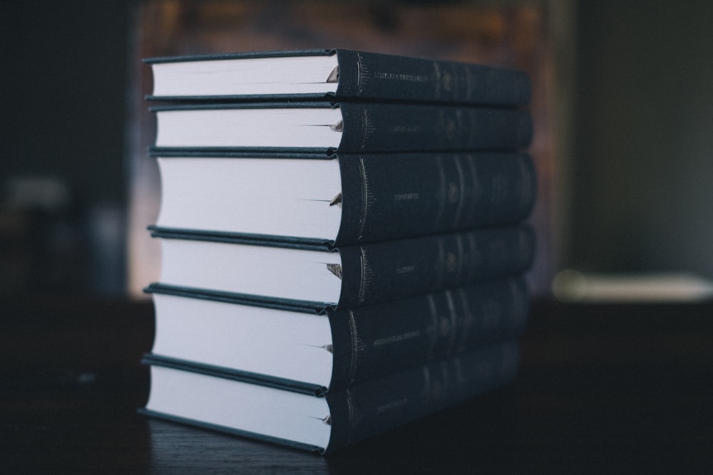 stack of books on wooden table