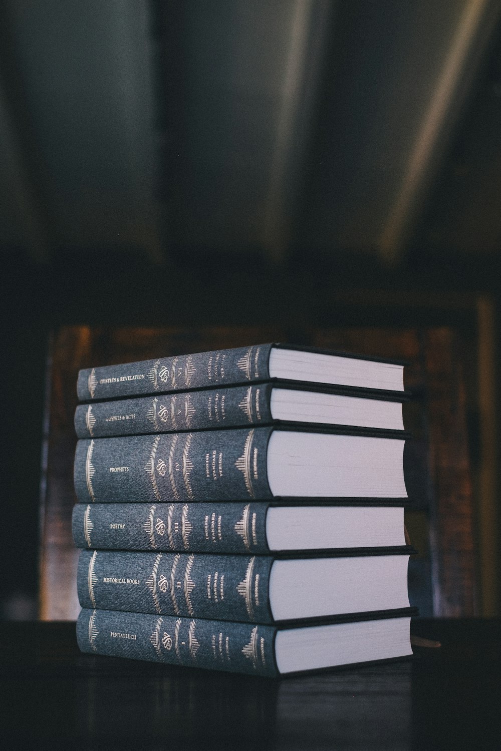 a stack of books sitting on top of a wooden table