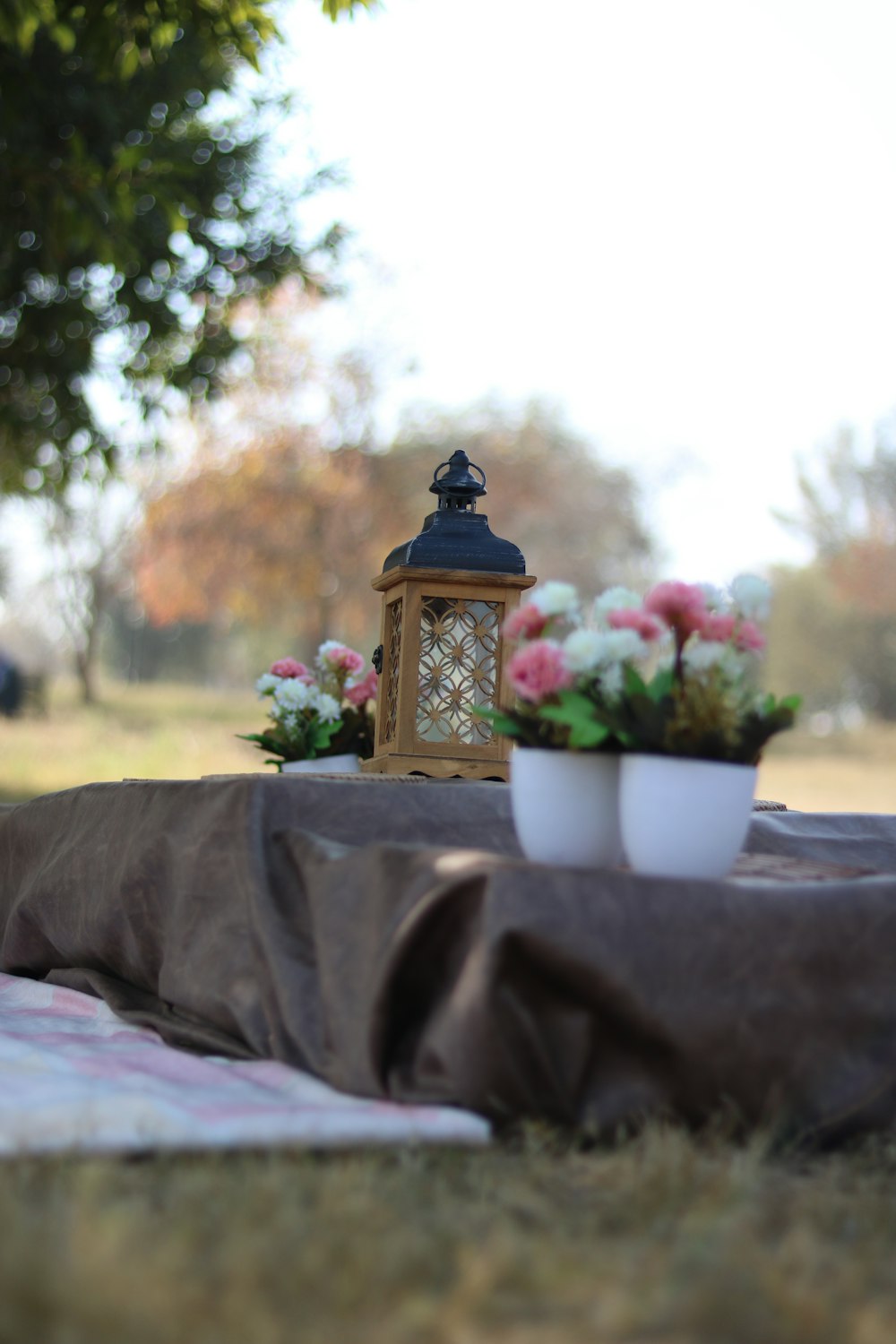 white ceramic pot with flower on table