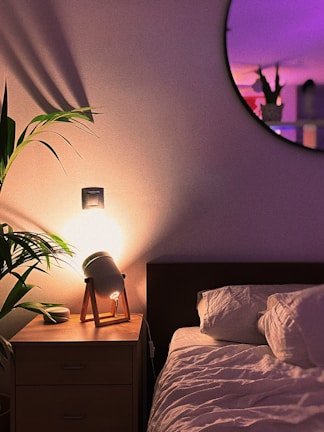 A serene bedroom scene with ambient lighting and plants.