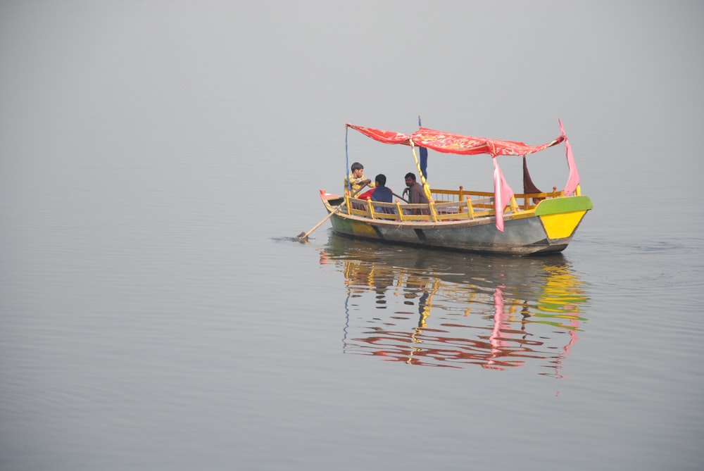 people riding on boat on body of water during daytime