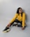 woman in yellow long sleeve shirt and black pants sitting on white floor