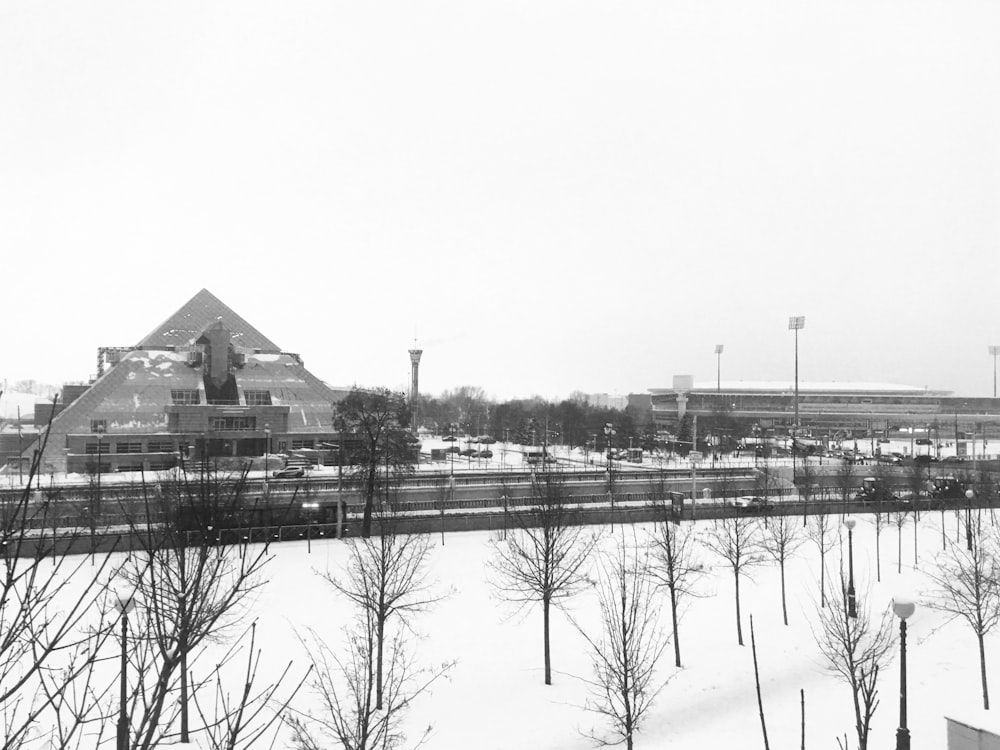 grayscale photo of body of water near building